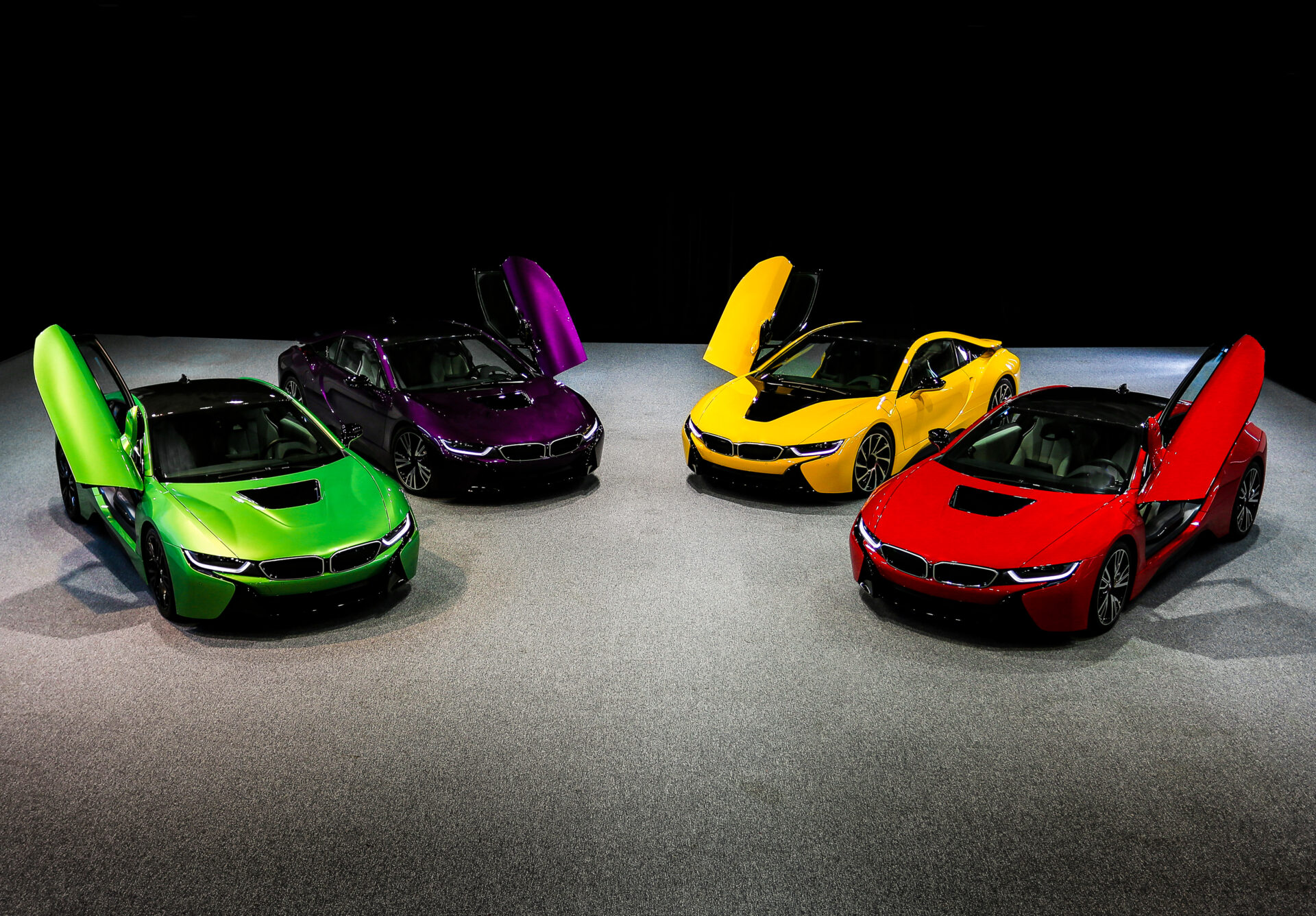 Green, yellow, red, purple, violet sedan sport cars standing on